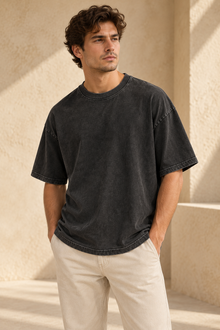 Man wearing a washed black relaxed drop-shoulder T-shirt